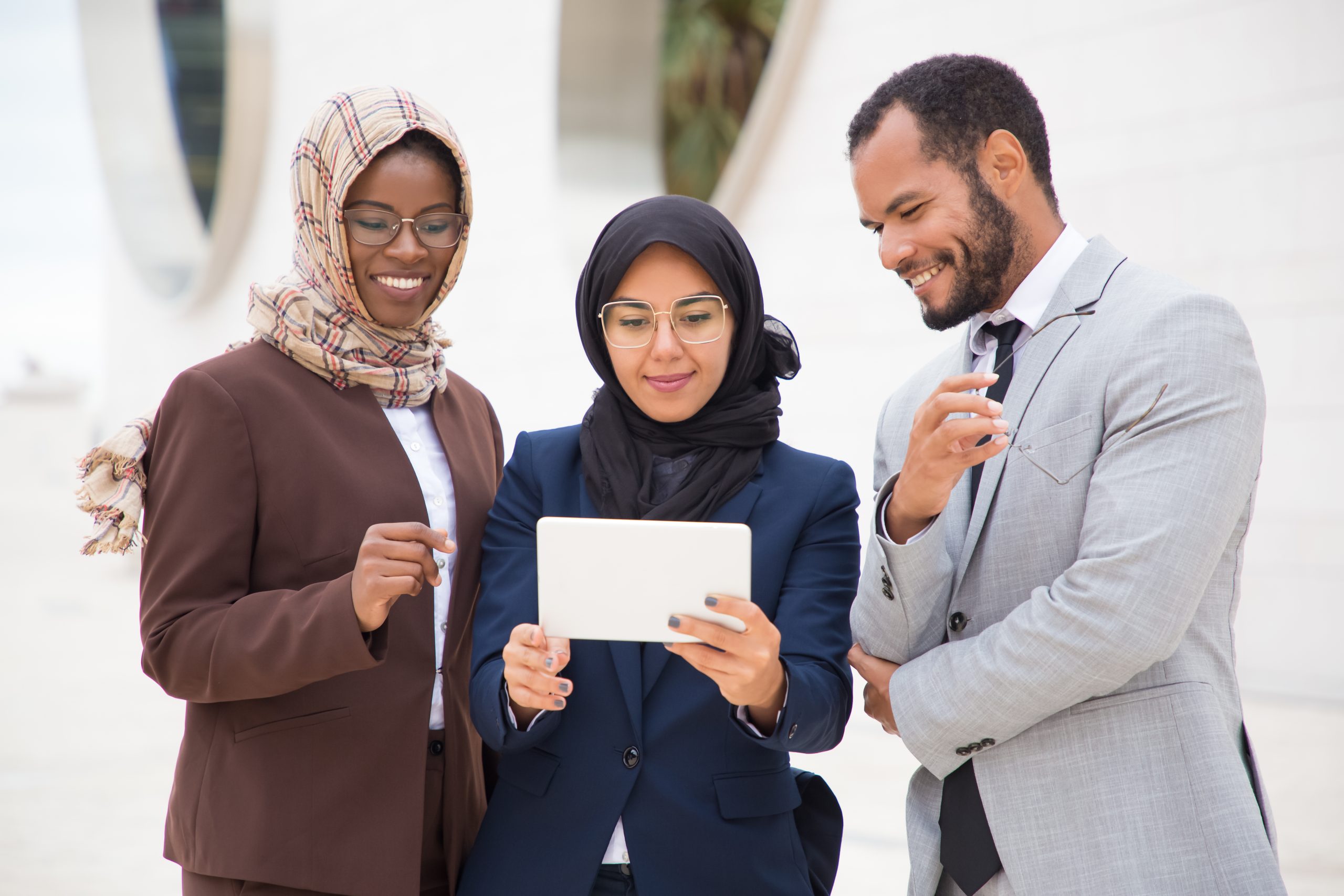 front view smiling managers using tablet outdoors scaled