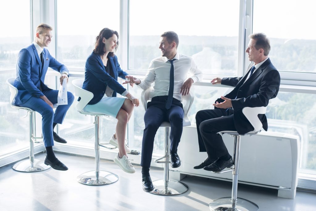 group businesspeople sitting stool office